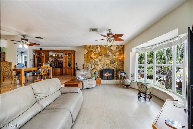 813 105th Ave N, Naples, FL 34108 - living area featuring a ceiling fan, wood finished floors, and a fireplace