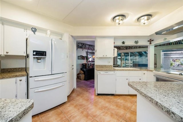 813 105th Ave N, Naples, FL 34108 - kitchen with white appliances, white cabinets, light tile patterned floors, and light countertops