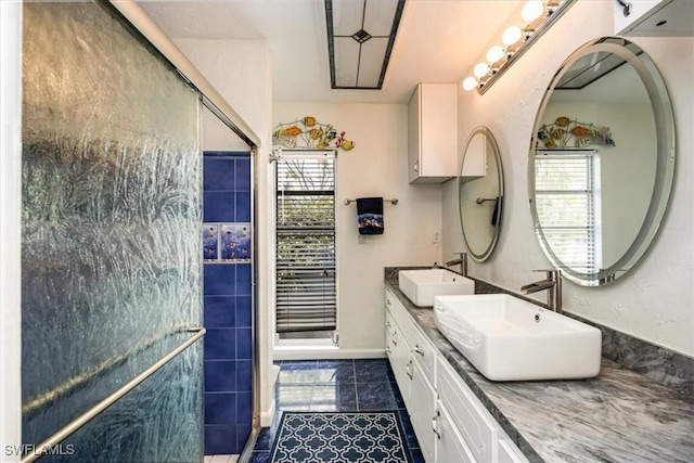 813 105th Ave N, Naples, FL 34108 - bathroom featuring plenty of natural light, double vanity, tiled shower, and tile patterned floors