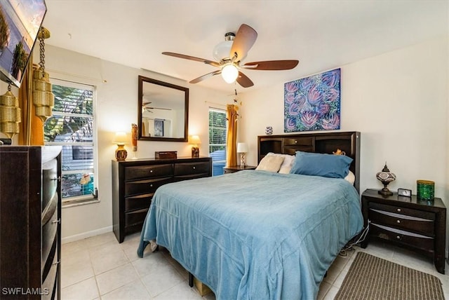 813 105th Ave N, Naples, FL 34108 - bedroom with light tile patterned floors and ceiling fan