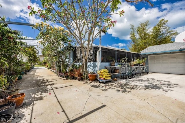 813 105th Ave N, Naples, FL 34108 - view of patio featuring a sunroom and driveway