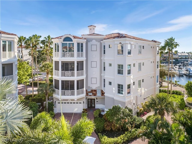 14356 Harbour Landings Dr Unit 6C, Fort Myers, FL 33908 - view of property featuring a garage, a water view, and driveway