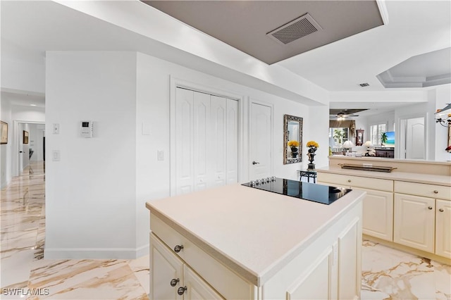 14356 Harbour Landings Dr Unit 6C, Fort Myers, FL 33908 - kitchen with light marble finish floors, black electric stovetop, light countertops, and a center island