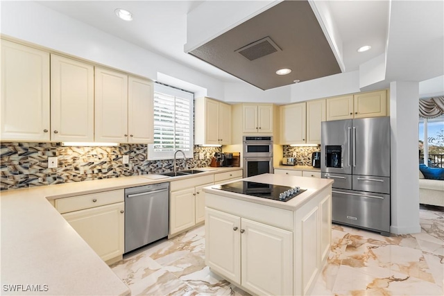14356 Harbour Landings Dr Unit 6C, Fort Myers, FL 33908 - kitchen with stainless steel appliances, a sink, cream cabinets, light marble finish floors, and light countertops