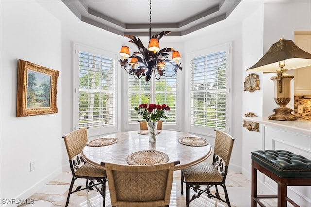 14356 Harbour Landings Dr Unit 6C, Fort Myers, FL 33908 - dining area featuring a chandelier, a tray ceiling, healthy amount of natural light, and baseboards