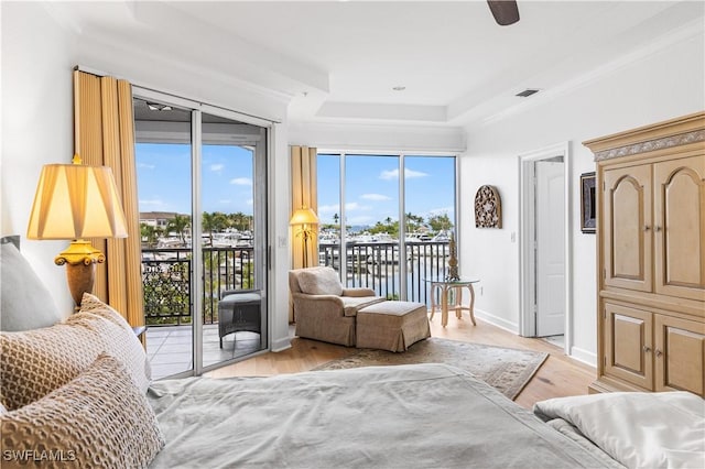 14356 Harbour Landings Dr Unit 6C, Fort Myers, FL 33908 - bedroom featuring access to outside, light wood-style flooring, crown molding, a tray ceiling, and baseboards