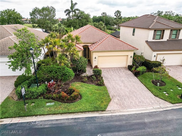 3180 Bramble Cove Ct, Fort Myers, FL 33905 - view of front facade with a tile roof, driveway, an attached garage, a front yard, and stucco siding