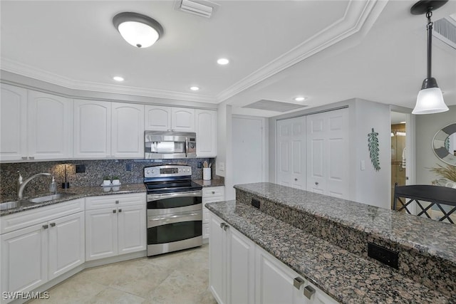 5 Bluebill Ave Unit 812, Naples, FL 34108 - kitchen with visible vents, a sink, dark stone counters, and stainless steel appliances