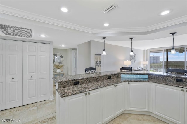 5 Bluebill Ave Unit 812, Naples, FL 34108 - kitchen featuring dark stone counters, white cabinets, and visible vents