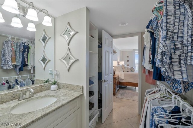 5 Bluebill Ave Unit 812, Naples, FL 34108 - ensuite bathroom with tile patterned flooring, ensuite bath, a notable chandelier, and vanity