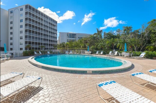 5 Bluebill Ave Unit 812, Naples, FL 34108 - community pool featuring fence and a patio