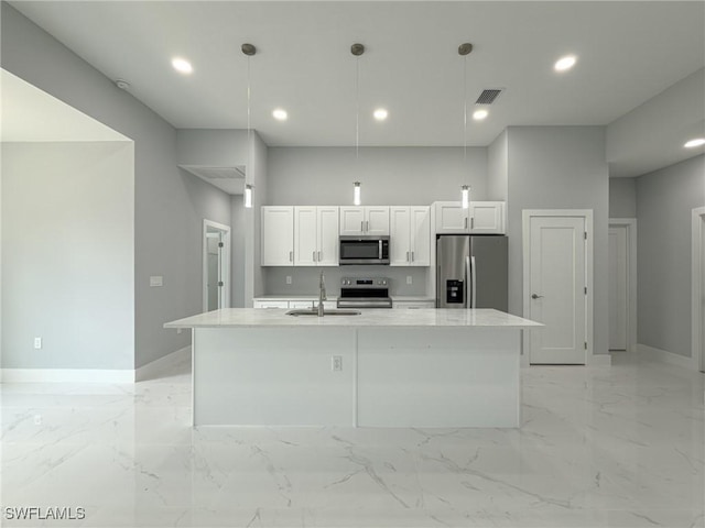 kitchen with a kitchen island with sink, visible vents, appliances with stainless steel finishes, a sink, and white cabinetry