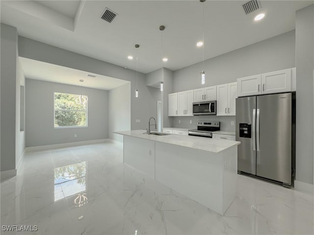 kitchen with a sink, baseboards, stainless steel appliances, and visible vents