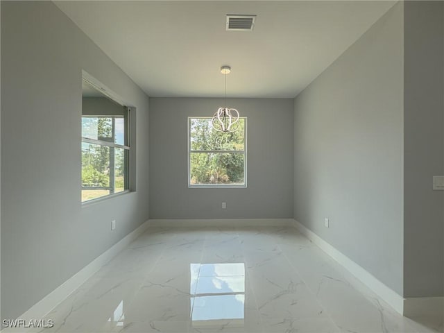 unfurnished dining area with an inviting chandelier, baseboards, marble finish floor, and visible vents