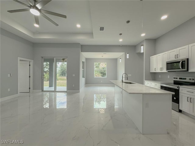 kitchen with a sink, marble finish floor, stainless steel appliances, open floor plan, and visible vents