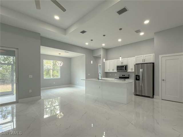 kitchen with visible vents, baseboards, ceiling fan, white cabinets, and stainless steel appliances