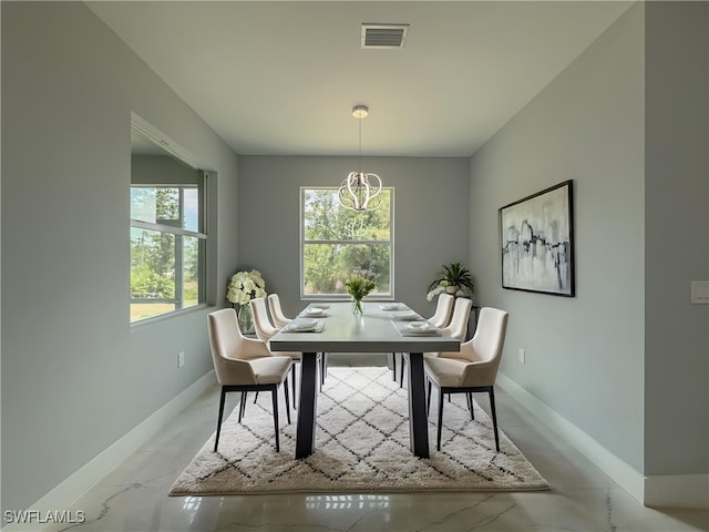 dining room with baseboards, visible vents, and an inviting chandelier