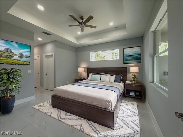 bedroom with visible vents, baseboards, marble finish floor, a tray ceiling, and recessed lighting