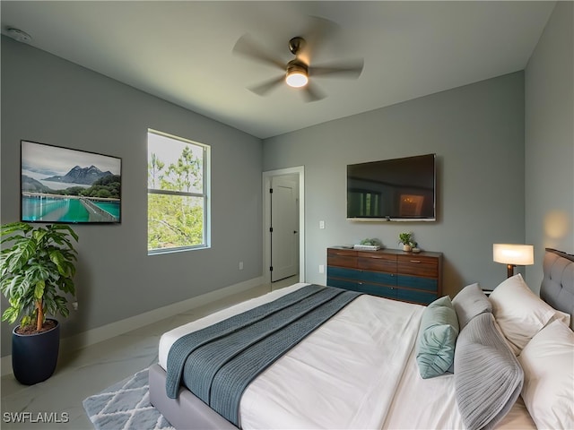 bedroom featuring baseboards and ceiling fan