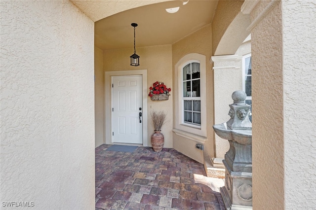 14194 Fall Creek Ct, Naples, FL 34114 - doorway to property featuring stucco siding