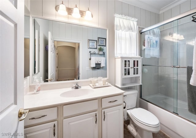14194 Fall Creek Ct, Naples, FL 34114 - bathroom with toilet, vanity, bath / shower combo with glass door, and crown molding