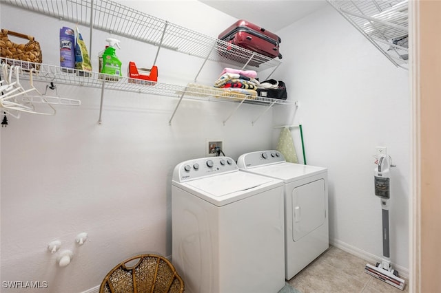 14194 Fall Creek Ct, Naples, FL 34114 - laundry room featuring washing machine and dryer, baseboards, and light tile patterned flooring