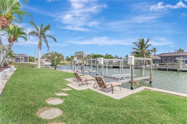 dock area featuring a lawn, a water view, and boat lift