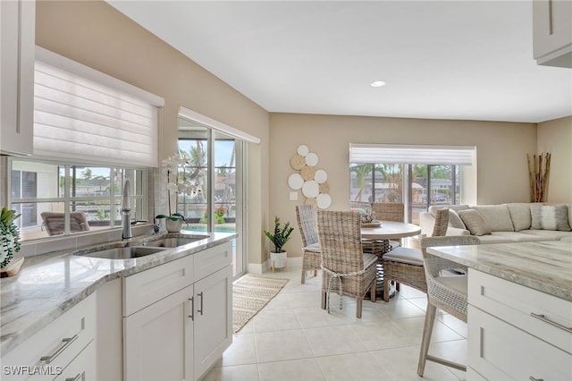 dining space with recessed lighting, light tile patterned flooring, and baseboards