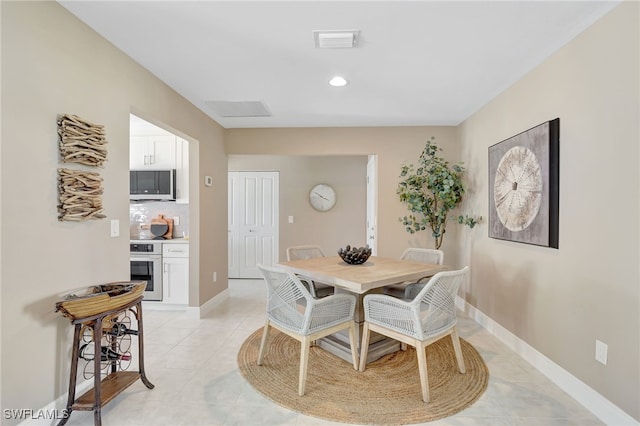 dining room with recessed lighting, light tile patterned flooring, visible vents, and baseboards