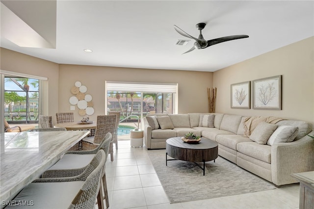 living area featuring a wealth of natural light, ceiling fan, recessed lighting, and visible vents