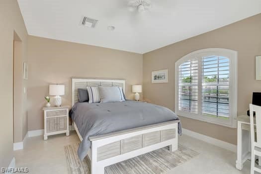 bedroom featuring visible vents, light carpet, and baseboards