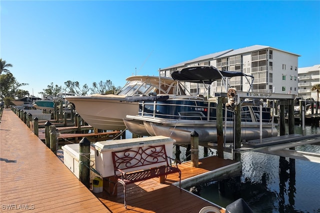 dock area featuring boat lift and a water view
