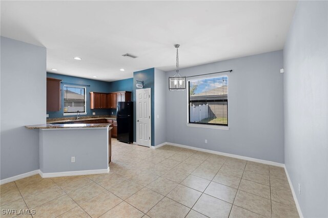 1322 SW 22nd Ave, Cape Coral, FL 33991 - kitchen featuring freestanding refrigerator, a wealth of natural light, light tile patterned floors, and pendant lighting