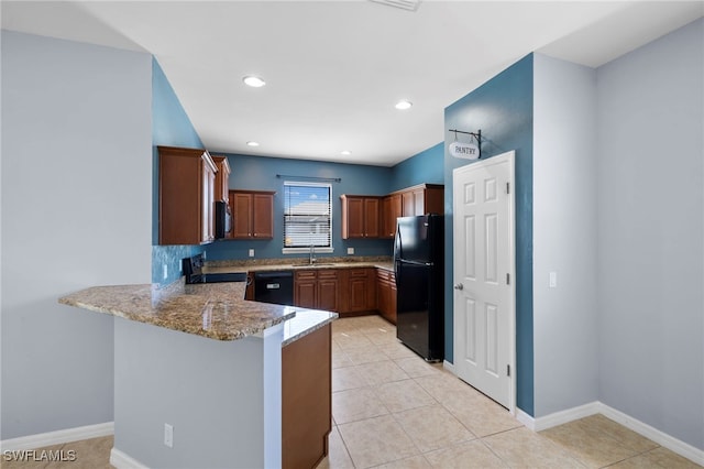 1322 SW 22nd Ave, Cape Coral, FL 33991 - kitchen featuring light stone countertops, a peninsula, baseboards, and black appliances