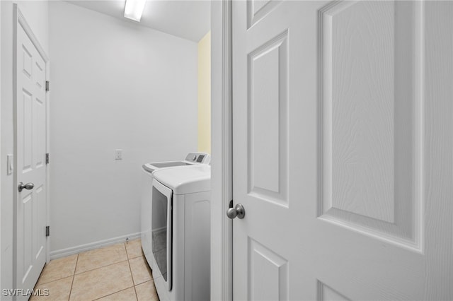 1322 SW 22nd Ave, Cape Coral, FL 33991 - washroom with washing machine and dryer, baseboards, laundry area, and light tile patterned floors