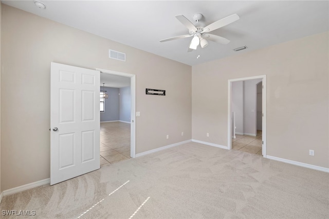 1322 SW 22nd Ave, Cape Coral, FL 33991 - carpeted spare room with baseboards, tile patterned flooring, visible vents, and ceiling fan with notable chandelier
