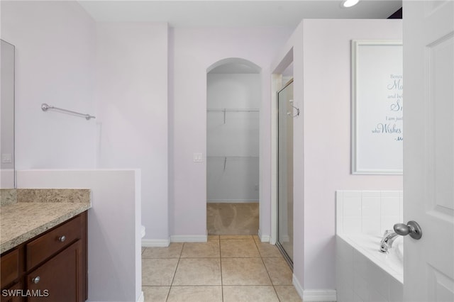 1322 SW 22nd Ave, Cape Coral, FL 33991 - full bathroom with a walk in closet, vanity, a garden tub, and a stall shower