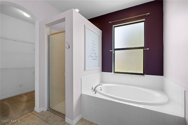 1322 SW 22nd Ave, Cape Coral, FL 33991 - bathroom with a garden tub, a stall shower, a spacious closet, baseboards, and tile patterned flooring