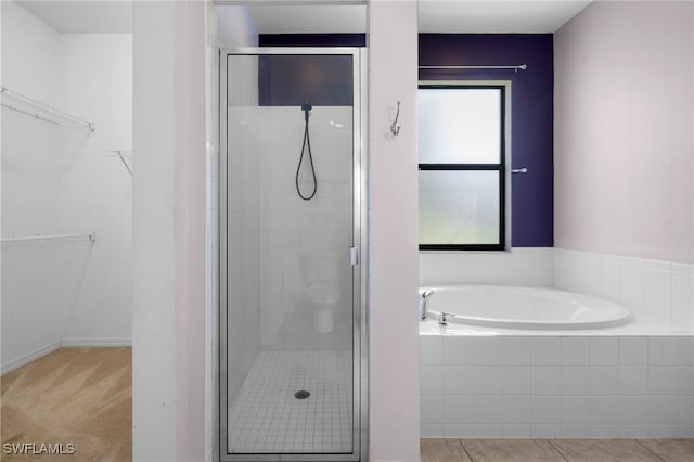 1322 SW 22nd Ave, Cape Coral, FL 33991 - bathroom featuring a walk in closet, a bath, and a shower stall