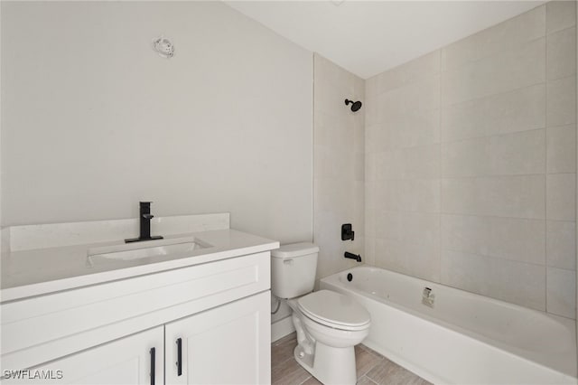bathroom featuring toilet, washtub / shower combination, wood finished floors, and vanity