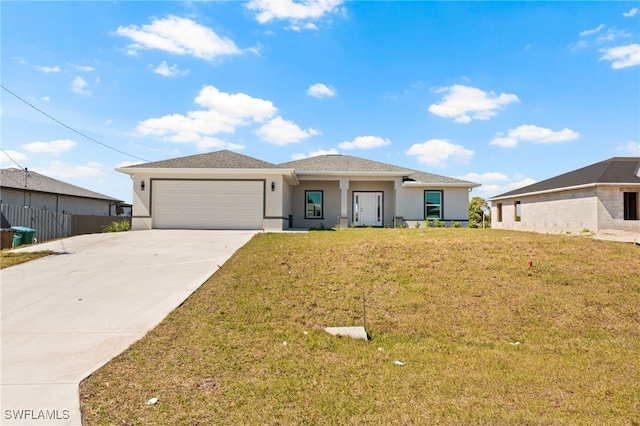 view of front of home with driveway, a front yard, stucco siding, and an attached garage
