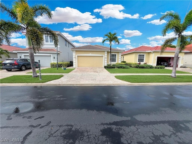 8799 Spring Mountain Way, Fort Myers, FL 33908 - view of front of property with a tile roof, stucco siding, driveway, and a front lawn