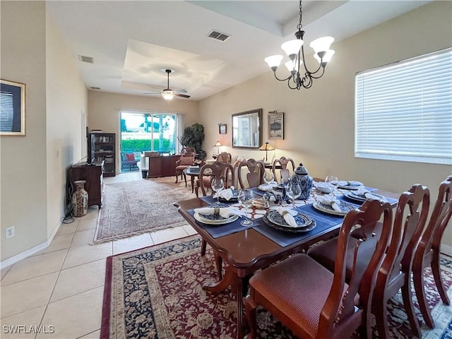 8799 Spring Mountain Way, Fort Myers, FL 33908 - dining room featuring visible vents, light tile patterned floors, and a tray ceiling