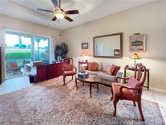 8799 Spring Mountain Way, Fort Myers, FL 33908 - living room featuring baseboards, light tile patterned flooring, a ceiling fan, and a tray ceiling