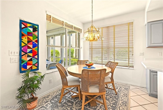 27071 Lake Harbor Ct Unit 103, Bonita Springs, FL 34134 - dining space with a chandelier, plenty of natural light, and baseboards