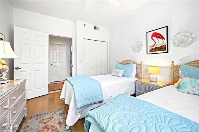 27071 Lake Harbor Ct Unit 103, Bonita Springs, FL 34134 - bedroom with wood finished floors, a closet, and ceiling fan