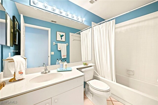 27071 Lake Harbor Ct Unit 103, Bonita Springs, FL 34134 - bathroom featuring vanity, toilet, shower / bath combo, and tile patterned floors