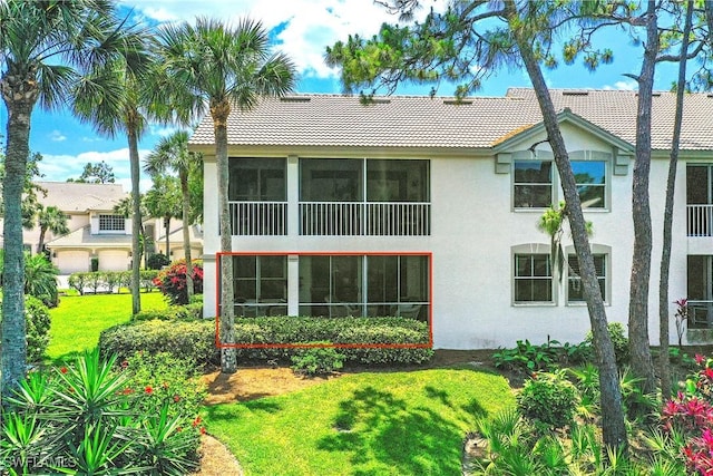 27071 Lake Harbor Ct Unit 103, Bonita Springs, FL 34134 - back of property with a tile roof, stucco siding, and a yard
