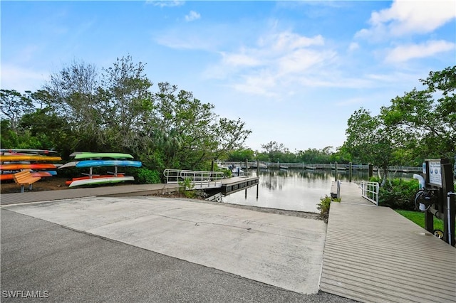 27071 Lake Harbor Ct Unit 103, Bonita Springs, FL 34134 - dock featuring a boat ramp and a water view