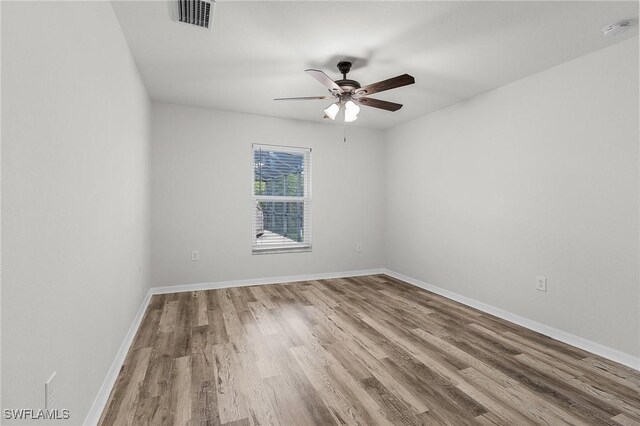 2626 SW 22nd Ave, Cape Coral, FL 33914 - empty room with baseboards, wood finished floors, visible vents, and ceiling fan